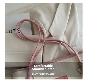 Dettaglio borsa shopper pied-de-poule con tracolla in pelle rosa e anello in metallo