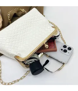 Macro view of white woven rectangular handbag showing internal space for phone and umbrella