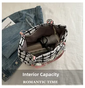 Detail of tweed tote bag showing interior storage capacity for wallet, phone, and sunglasses