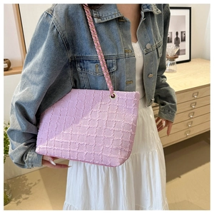 Pink textured canvas tote bag with elegant gold chain strap and spacious design