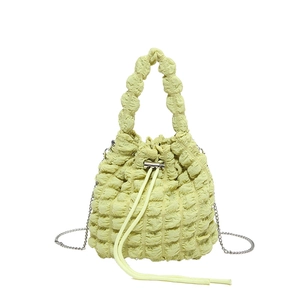 Fashionable light yellow popcorn texture bucket bag with drawstring and silver chain strap
