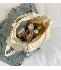 Interior view showing the large capacity and multiple pockets of this canvas tote bag