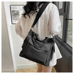 Black large capacity shoulder bag with adjustable strap and fashion label detail