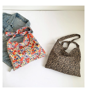 Flat lay of large canvas tote bags in colorful floral print and trendy leopard pattern