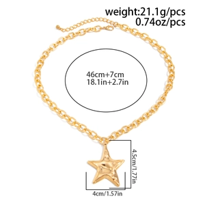 Macro view of gold star pendant with hammered texture and dimensions measurement guide