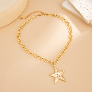 Golden starfish pendant necklace with chunky chain on minimalist beige background