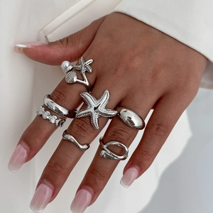 Silver knuckle ring set featuring ocean elements like starfish, shells and pearls