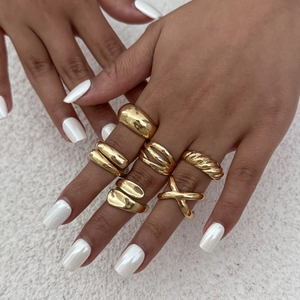 Set of six gold plated liquid metal rings with various irregular and textured designs