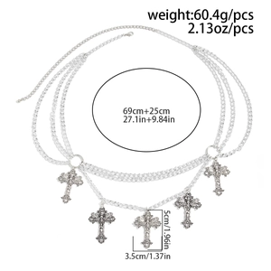Macro view of retro silver multilayer waist chain with hollow cross pendants