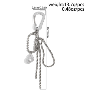 Detail view of silver chain tassel keychain with rhinestone fringe and irregular pearl