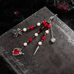 Gothic punk keychain with silver chains, metallic spider, and dagger charms on dark lace