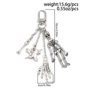 Detail view of gothic skeleton keychain charms with ghost and skull pendant elements