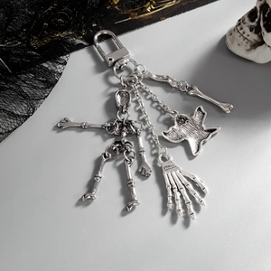 Macro shot of Gothic silver skeleton keychain with movable joints and skull hand detail