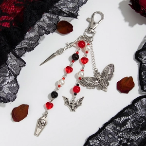 Gothic keychain featuring skull coffin and bat pendants with red heart beads on black lace