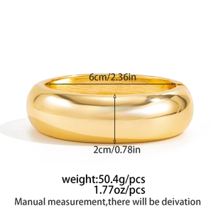 Polished gold wide cuff bangle with dimensions: 6cm inner diameter and 2cm width detail