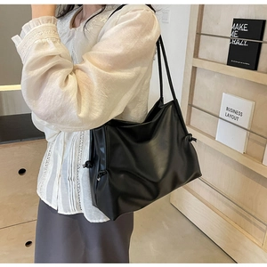 Soft black PU leather bucket tote bag with drawstring details and dual thin shoulder straps