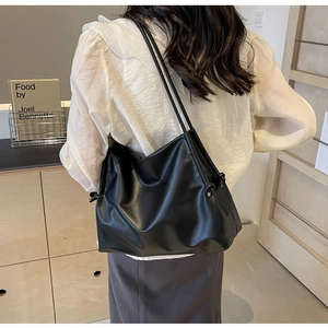 Minimalist black slouchy hobo shoulder bag shown on model for elegant daily styling