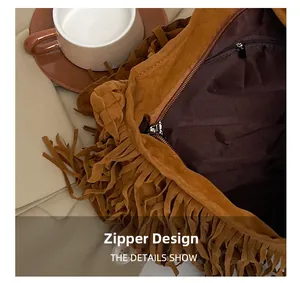 Dettaglio della chiusura a zip e della tasca interna di questa borsa marrone con frange