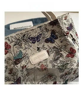 Detailed close-up of jacquard fabric tote bag with colorful butterfly embroidery patterns