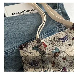 Detailed close-up of vintage butterfly jacquard fabric and leather strap on a tote bag