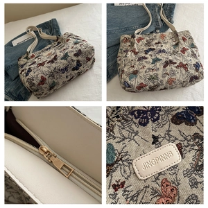 Detail of butterfly jacquard tote bag with leather strap and golden zipper closure