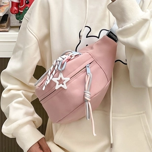 Nahaufnahme der rosa Canvas-Brusttasche mit Sternanhänger und modischem Gurt-Detail