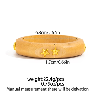 Detail view of yellow resin bangle with gold star studs showing size and weight specs