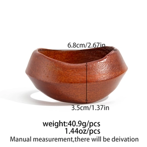 Macro shot of dark wooden bowl with irregular wavy edges and detailed grain texture