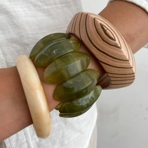 Ethnic style bracelet set featuring resin, olive green art glass, and striped wood bangles
