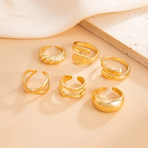 Detailed view of 6-piece gold adjustable ring set including twisted and geometric bands