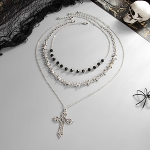 Detail of gothic layered necklaces with cross pendant and barbed wire thorns design