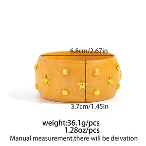 Detail view of a wide wooden vintage bangle with gold star studs and size measurements