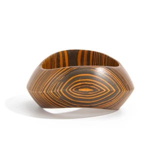 Vintage wide geometric wood bracelet featuring dark brown and orange concentric grain patterns