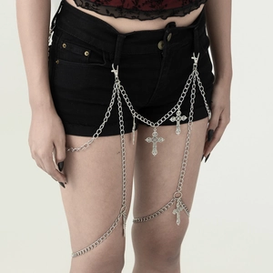 Gothic silver body chain with cross pendants on denim shorts for a punk aesthetic look