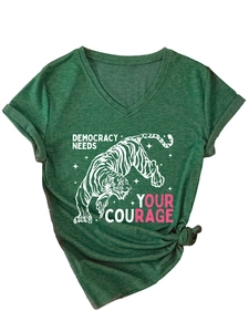 Dettaglio di una t-shirt con scollo a V verde scuro con stampa tigre e slogan