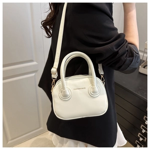 White mini shoulder bag in flat grain leather styled with a black blazer on a model