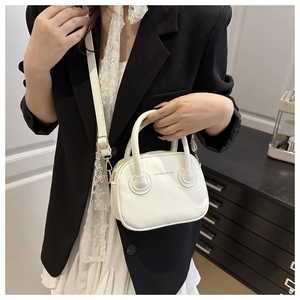 Close-up of a white mini handbag with gold hardware and Fashion & Bags text on matte PU
