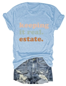 Dettaglio della t-shirt azzurra con stampa e degli shorts in denim con strappi