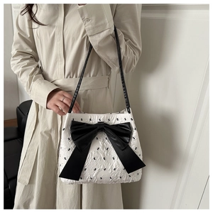Detail of white seersucker tote bag with black rabbit embroidery and satin bow