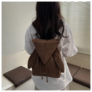 Brown suede backpack with cute rabbit ears and drawstring closure shown on model