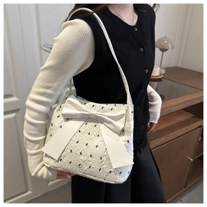 Detail of white seersucker tote bag showing the 3D texture and large decorative bow