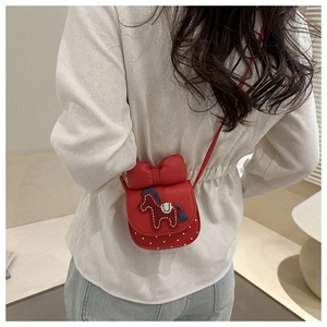 Dettaglio della mini borsa a tracolla rossa trapuntata con fiocco e ricamo a cavallo