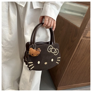 Detail shot of a dark brown cat-shaped handbag with embroidery and leopard print charm
