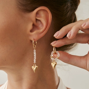 Asymmetric gold heart dangle earrings with clear faceted beads and round hoops