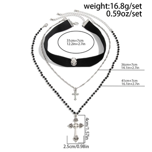 Detailed view of layered gothic necklaces with cross pendants and black velvet choker