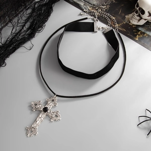 Detail of gothic cross necklace with black velvet choker and intricate silver engraving