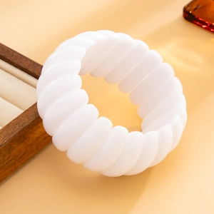 Close-up of white resin cuff bracelet with a unique wavy texture and stylish round silhouette