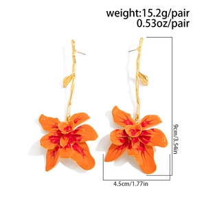 Detailed view of 3D gradient orange enamel flower earrings with golden branch and leaf