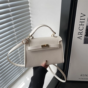 Elegant off-white crossbody bag with gold hardware and classic textured finish