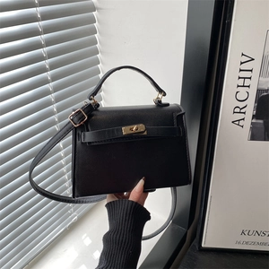 Vintage black lychee pattern tote bag with gold hardware and top handle shown by model